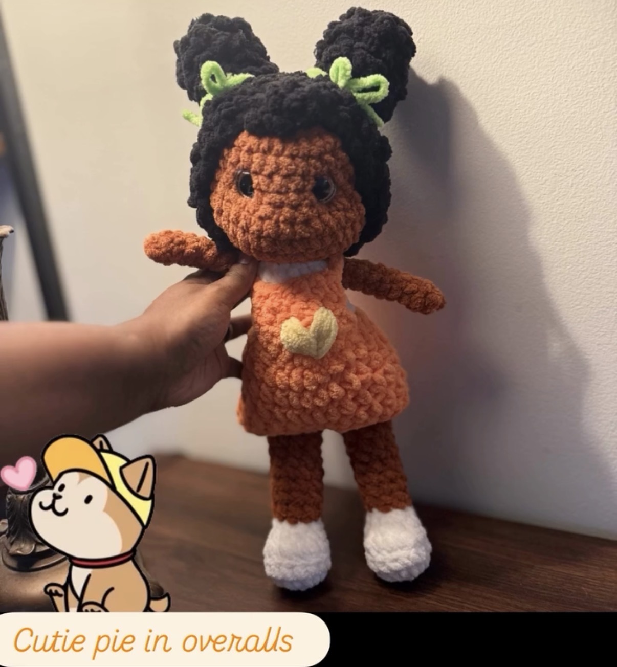 Handmade orange crochet character doll with black hood and green details